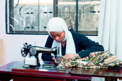 A young deaf student sewing